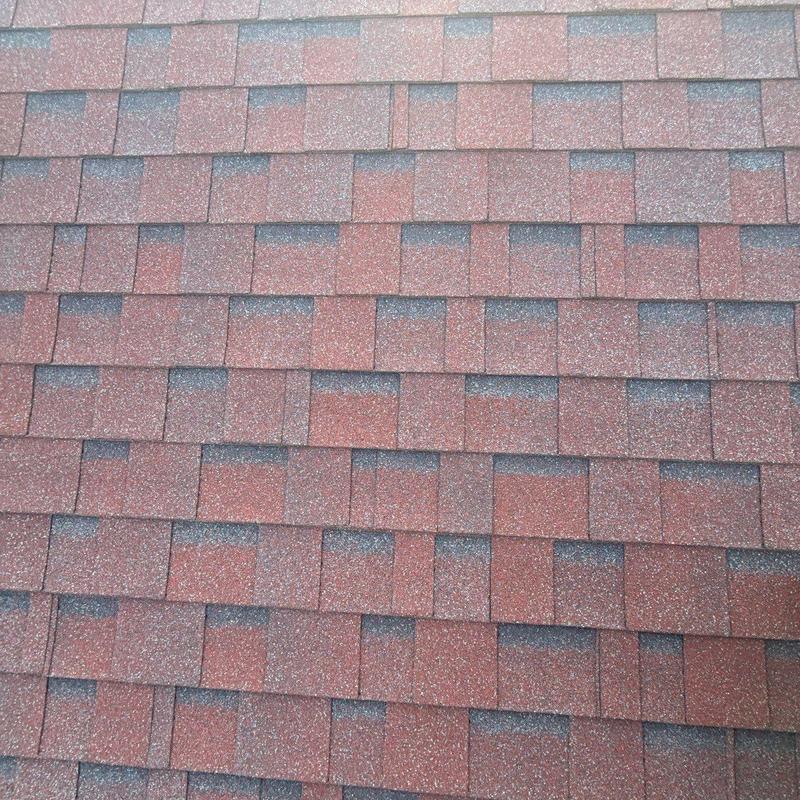 Asphalt roof shingles with hail damage signs