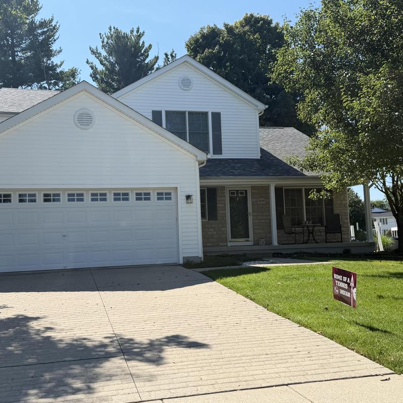 Vinyl siding on residential house exterior in sunlight