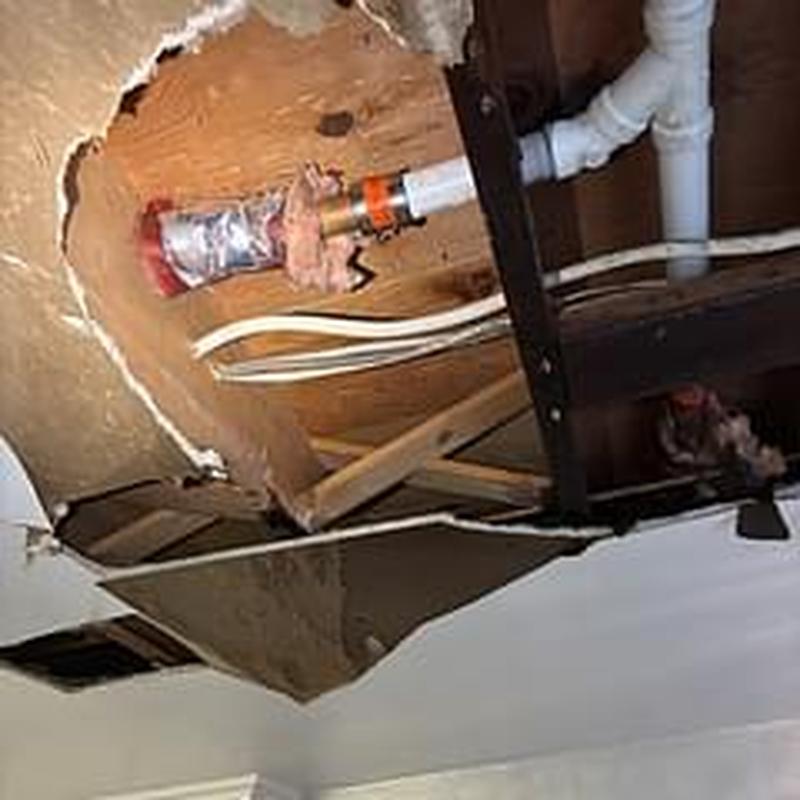 1 1/2 inch copper drain line in ceiling with leak repair