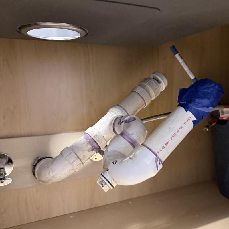 PVC drain pipes and fittings under kitchen sink installation PVC drain pipes and fittings under kitchen sink installation