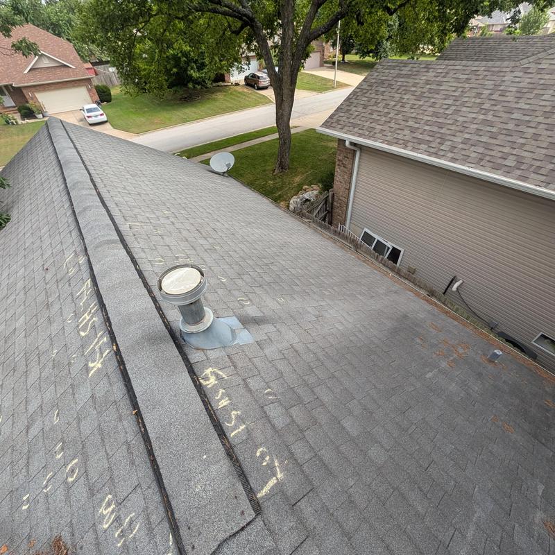 Asphalt shingle roof with vent and damage markings
