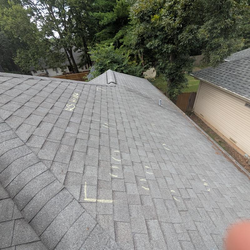 Roof shingles with chalk markings for damage inspection