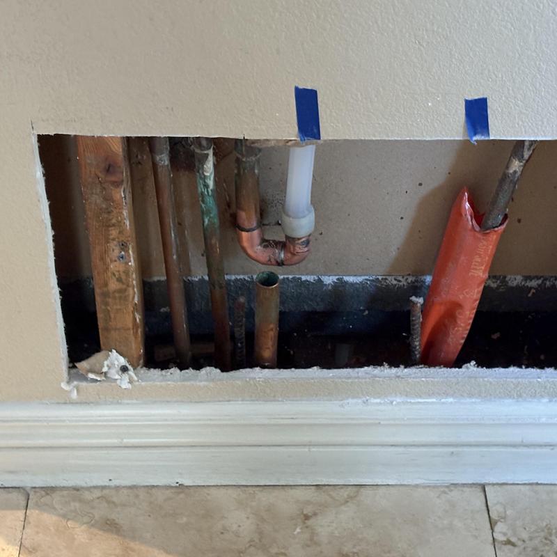 Three-quarter-inch PEX water line behind bathroom wall