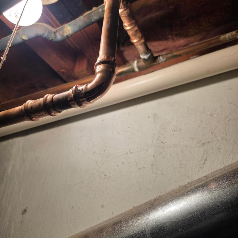 Copper plumbing pipe with new soldered joints in basement Copper plumbing pipe with new soldered joints in basement