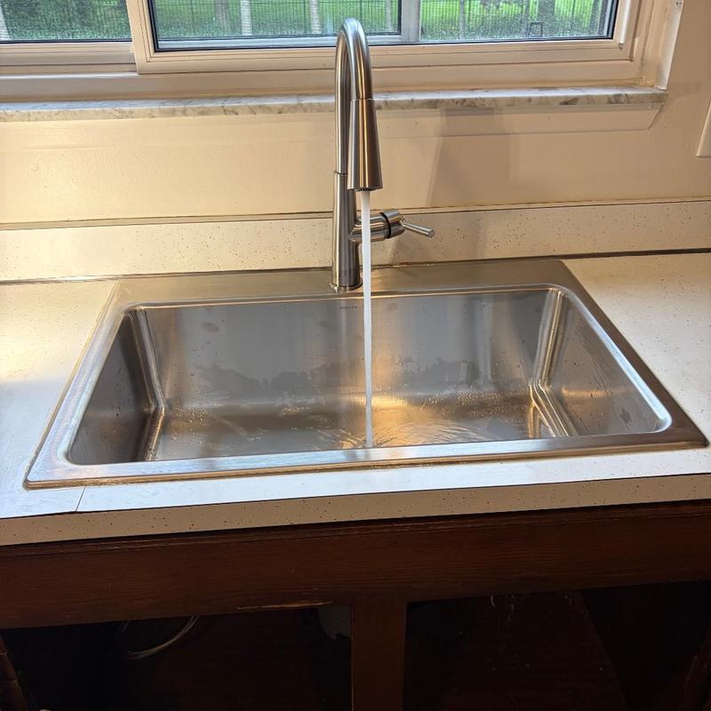 Kitchen sink with running faucet in countertop Kitchen sink with running faucet in countertop