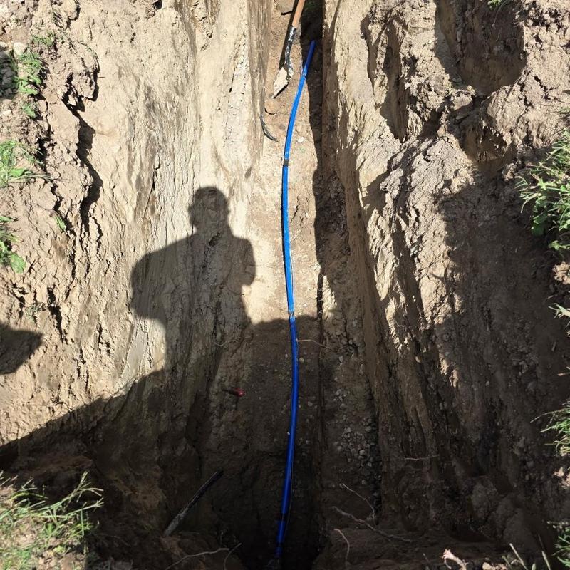 Water service poly pipe installation in trench Water service poly pipe installation in trench