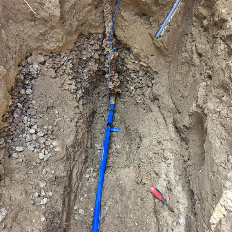 Poly water service line installed in trench Poly water service line installed in trench