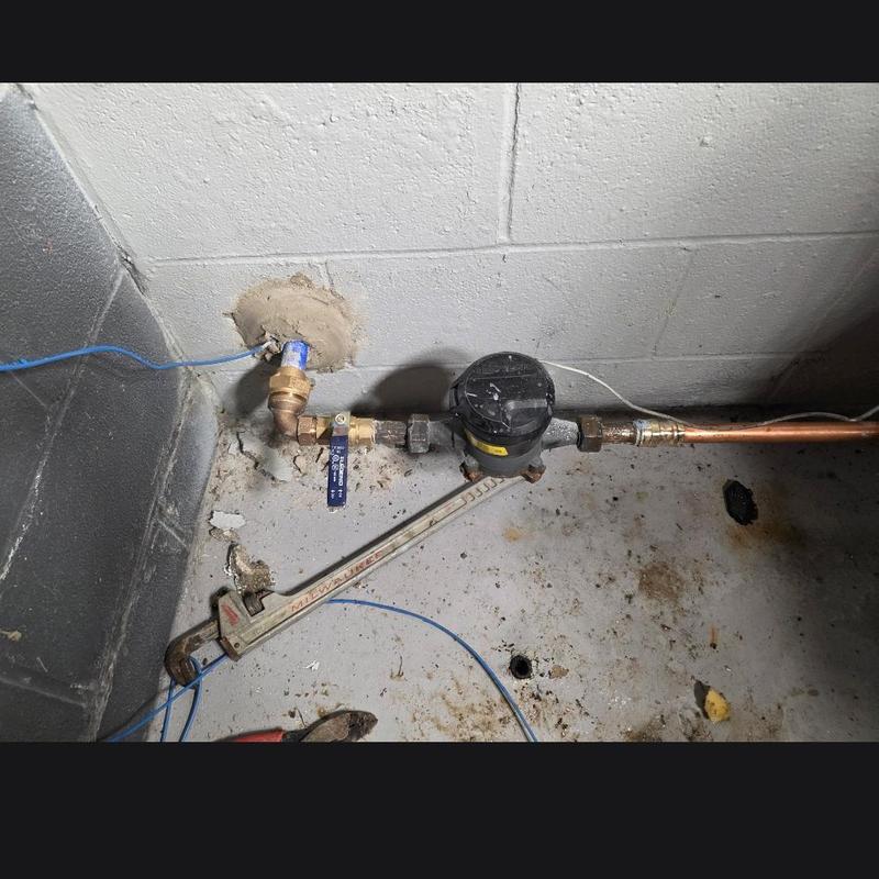 Water meter installation with copper piping in basement Water meter installation with copper piping in basement