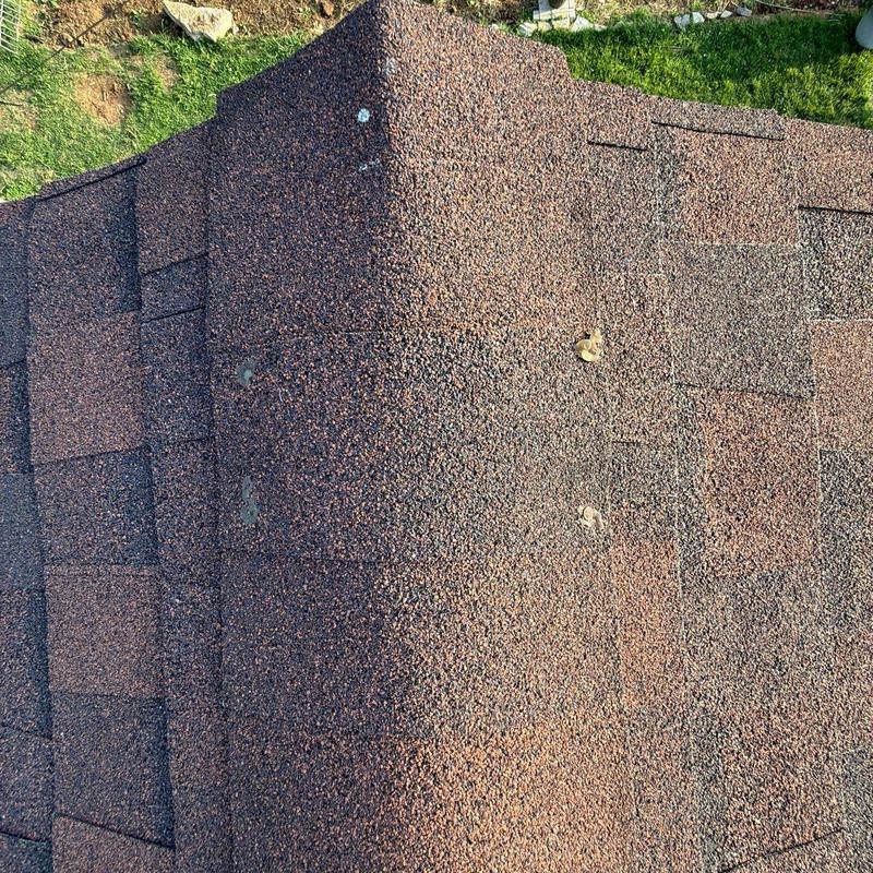Asphalt shingle roof with hail damage on ridge line