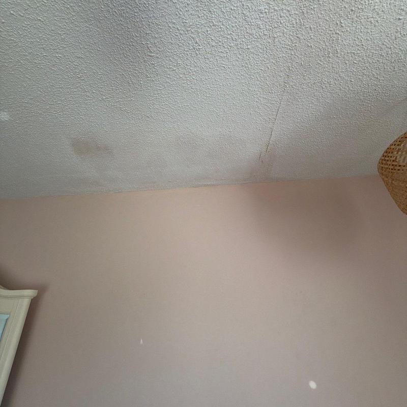 Ceiling drywall with water stains and crack damage