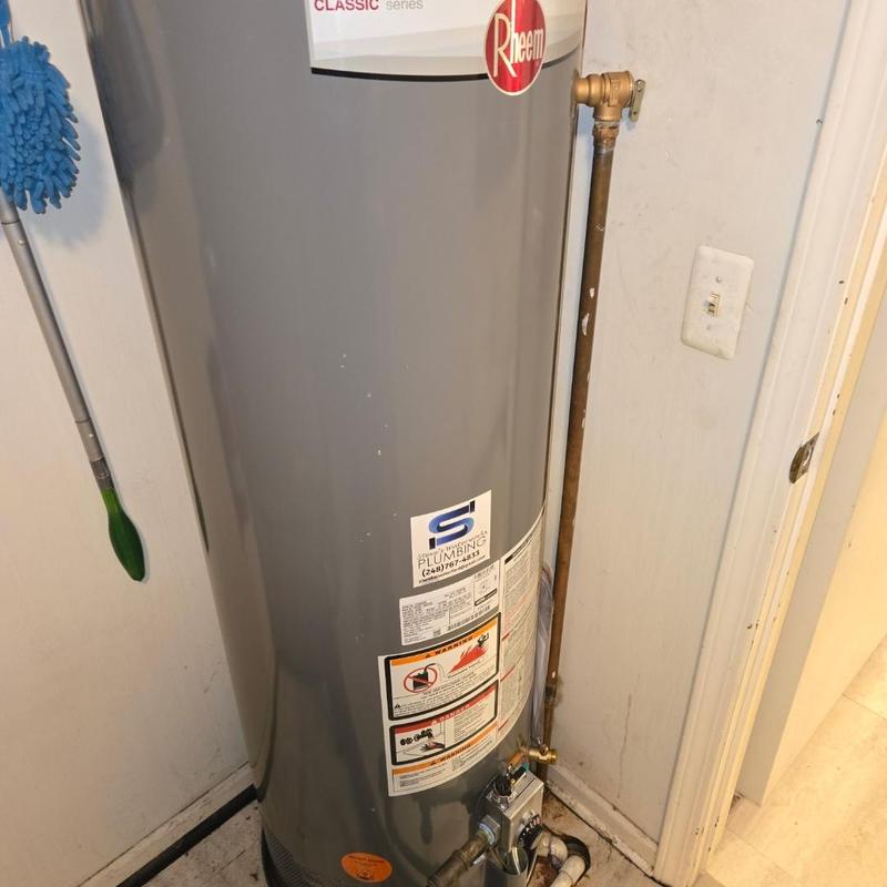 Water heater with copper piping installation in utility room Water heater with copper piping installation in utility room