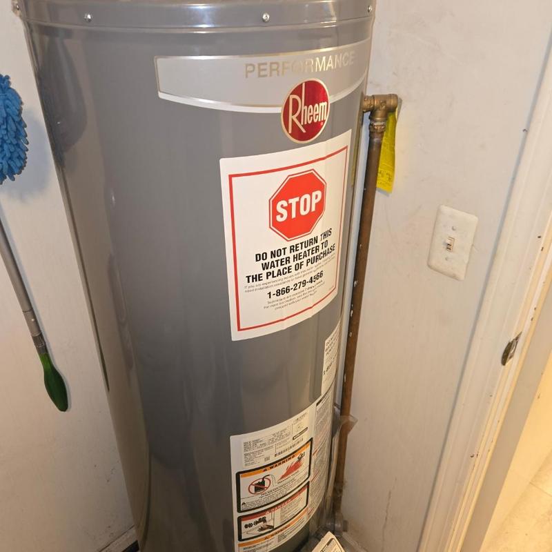 Water heater replacement in residential utility area Water heater replacement in residential utility area