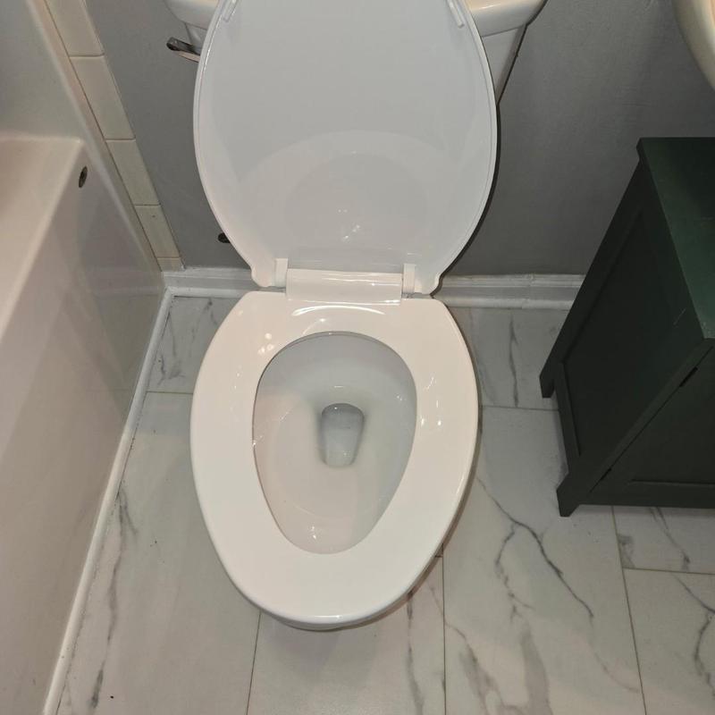 Toilet bowl and seat with open lid in bathroom Toilet bowl and seat with open lid in bathroom