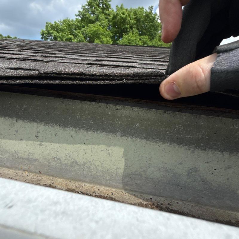 Roof shingles lifted for hail damage inspection
