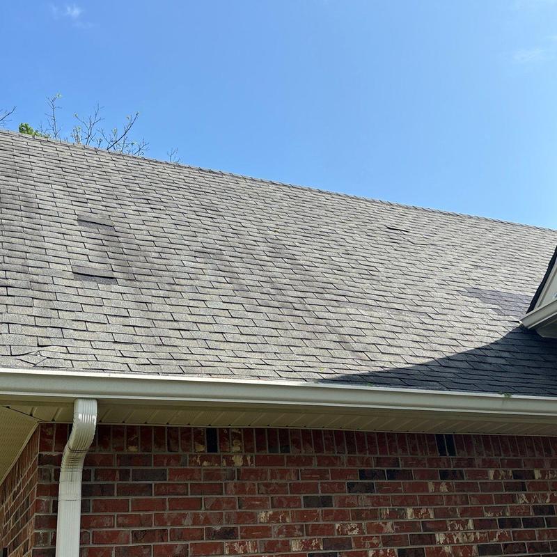 Asphalt shingle roofing with visible hail damage
