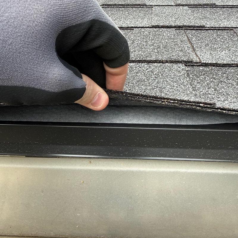 Roof shingles lifted for hail damage inspection