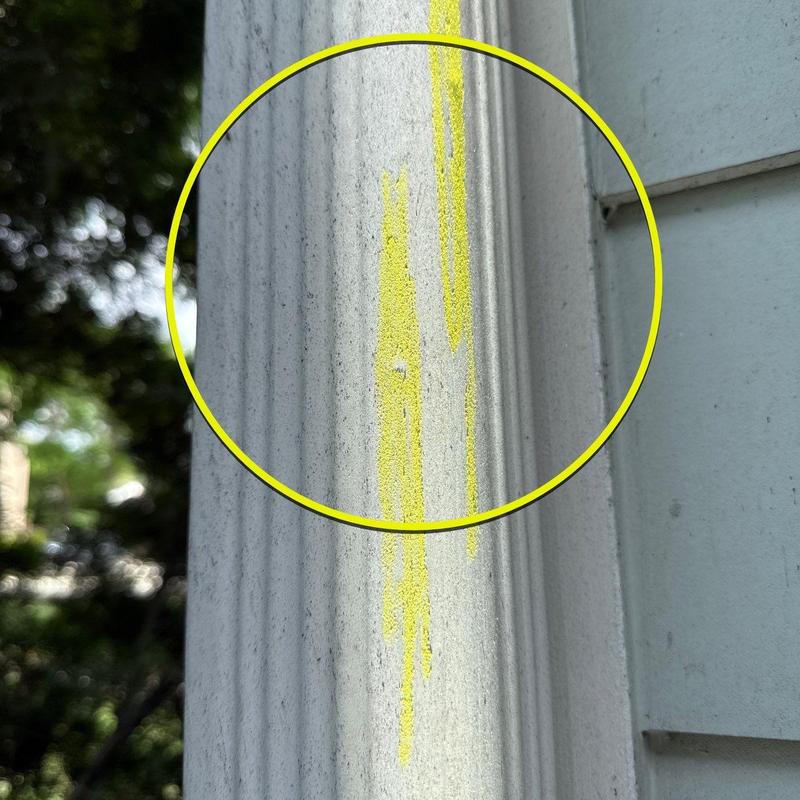 Painted exterior column with marked damage area