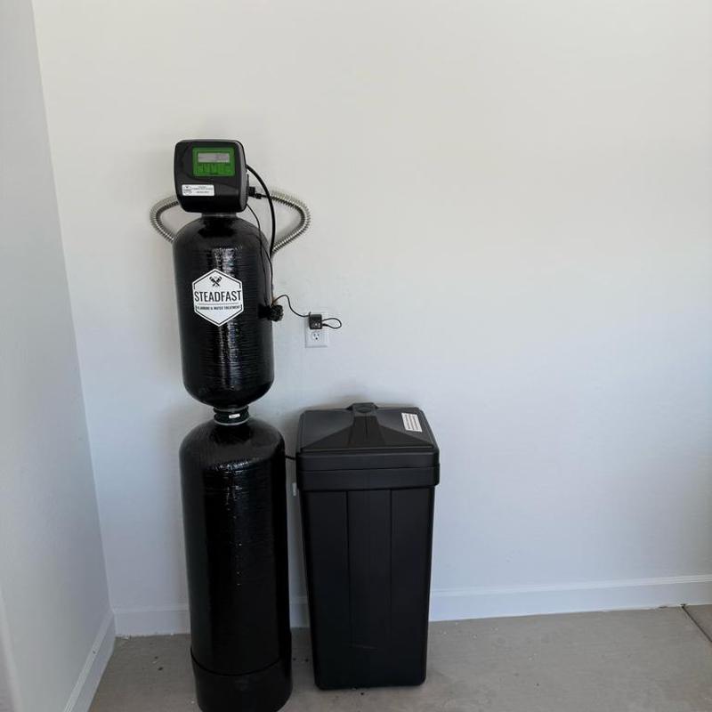 Water softener unit with brine tank installed indoors