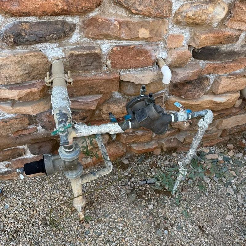 Pressure vacuum breaker and water service piping outdoors
