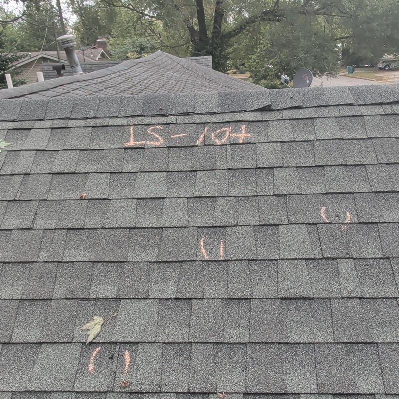 Asphalt shingle roof with storm damage markings