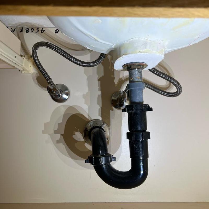 Bathroom sink drain and supply lines installation under sink