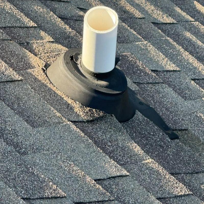 Pipe boot on shingle roof with glued shingles