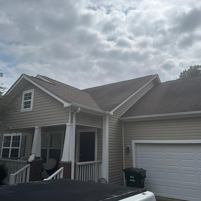 Asphalt shingle roof with porch and garage exterior