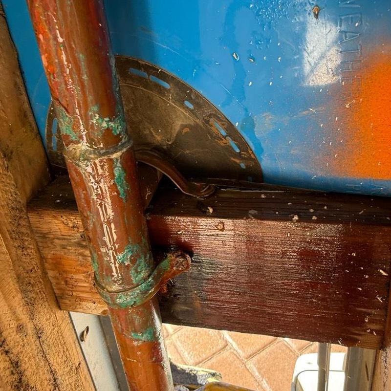 Corroded copper pipe leak at garage wall framing