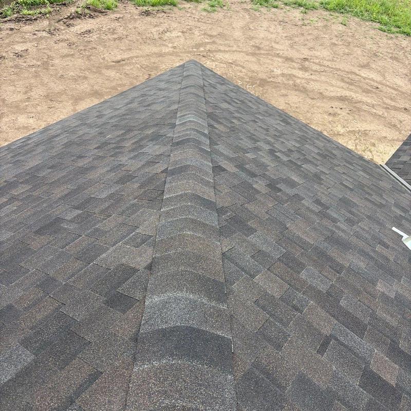 IKO Dynasty AR shingles on residential roof ridge IKO Dynasty AR shingles on residential roof ridge