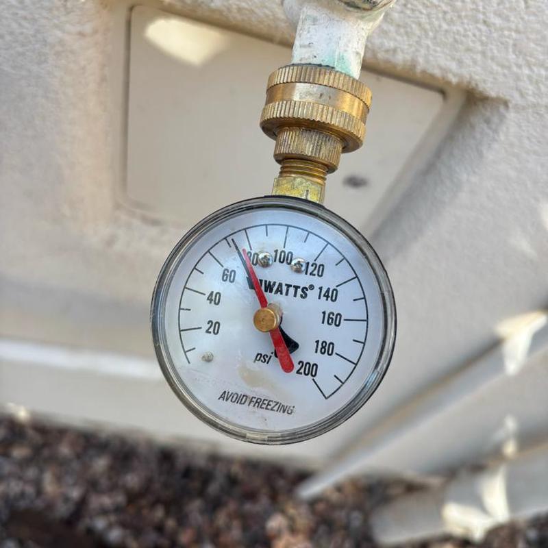 Pressure gauge on residential water pipe fitting