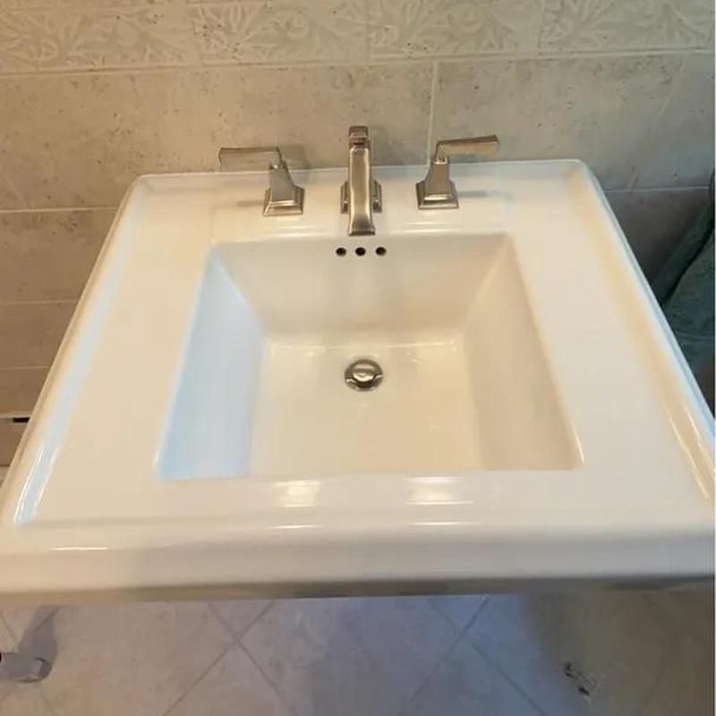Lavatory sink with modern chrome faucet and handles