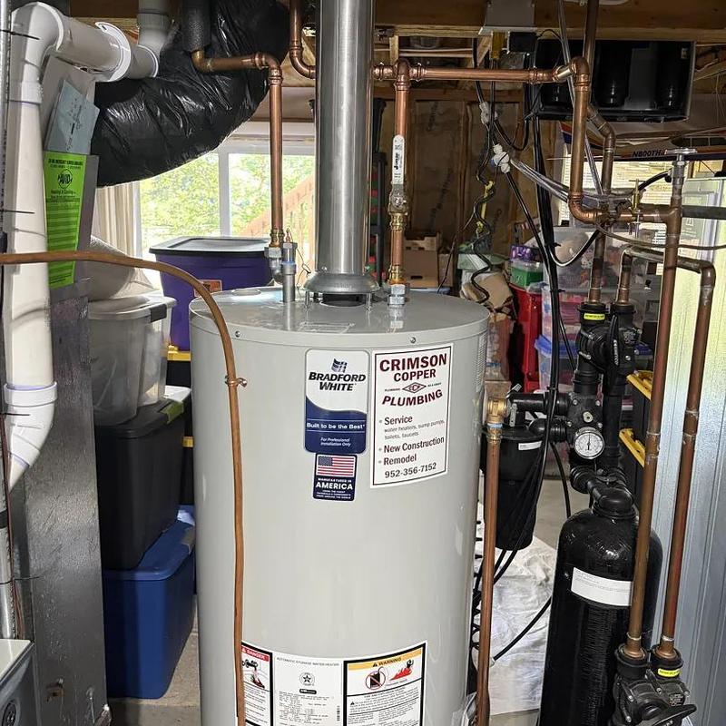 Water heater with copper plumbing and pressure gauge