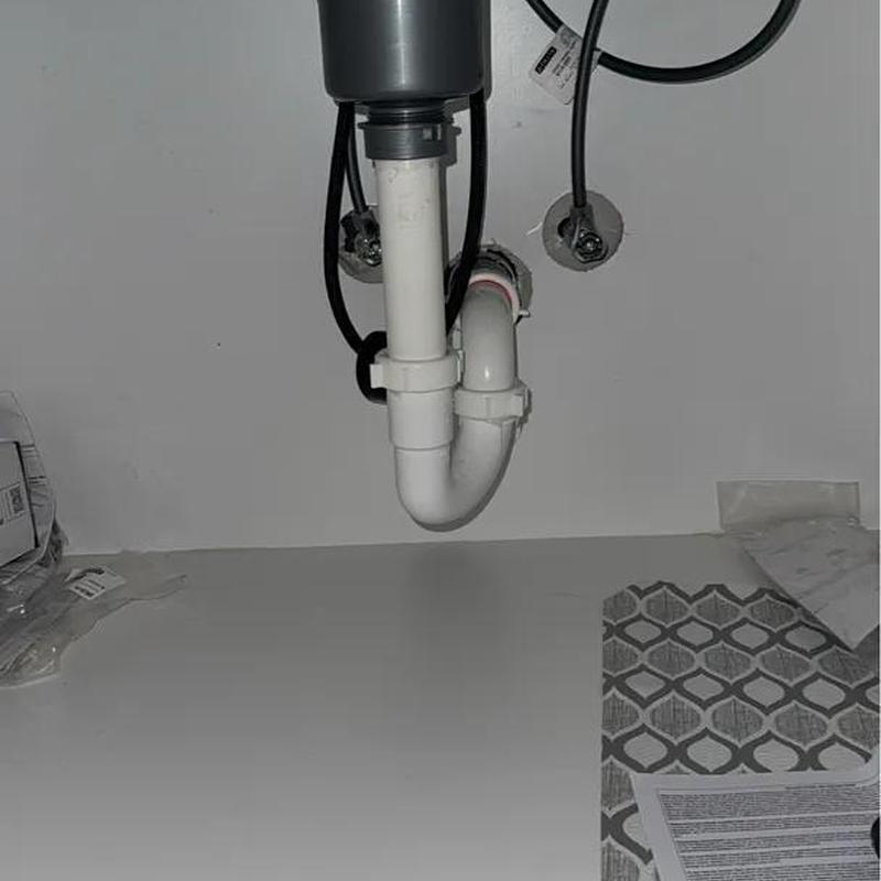 Laundry room faucet drain pipe and connections under sink