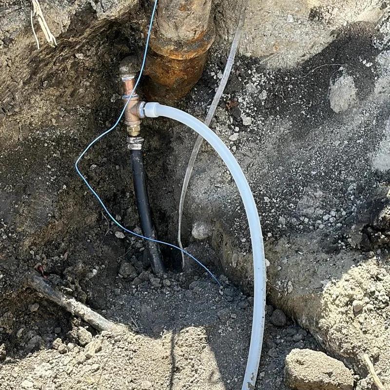 Underground shop bathroom plumbing installation in dirt