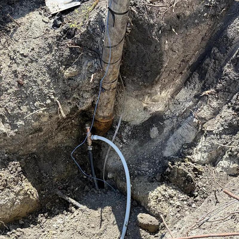 Underground plumbing pipe with fittings in trench