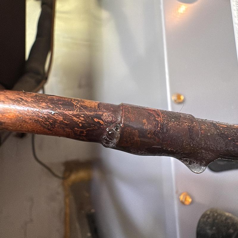 Copper refrigerant line with leak bubbles
