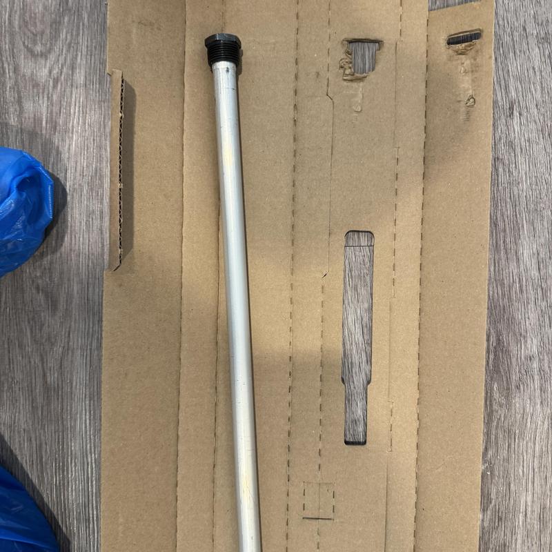 Water heater anode rod replacement part on cardboard background Water heater anode rod replacement part on cardboard background