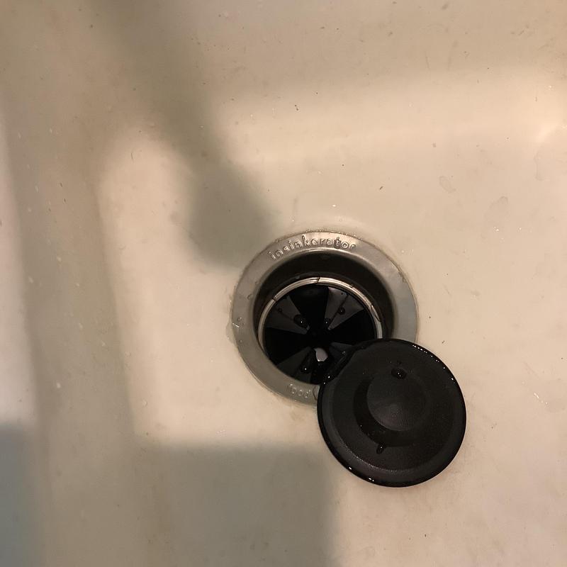 Garbage disposal drain flange with stopper in sink Garbage disposal drain flange with stopper in sink