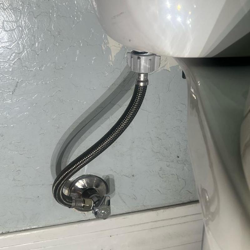 Toilet water supply line with quarter-turn angle stop installed