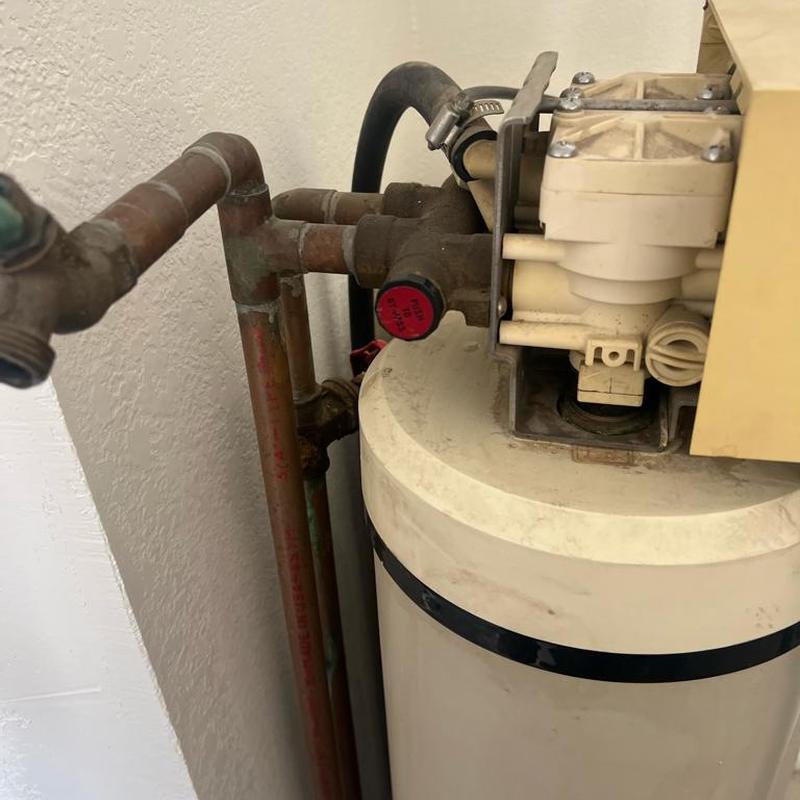 Water softener and connected copper piping system