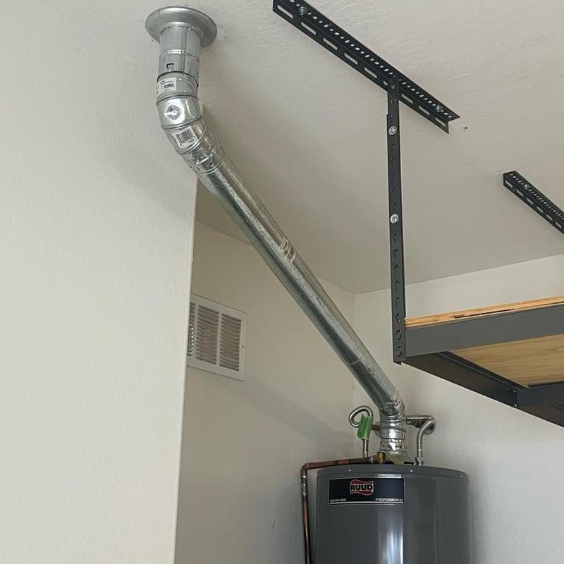 Water heater vent hood secured with screws