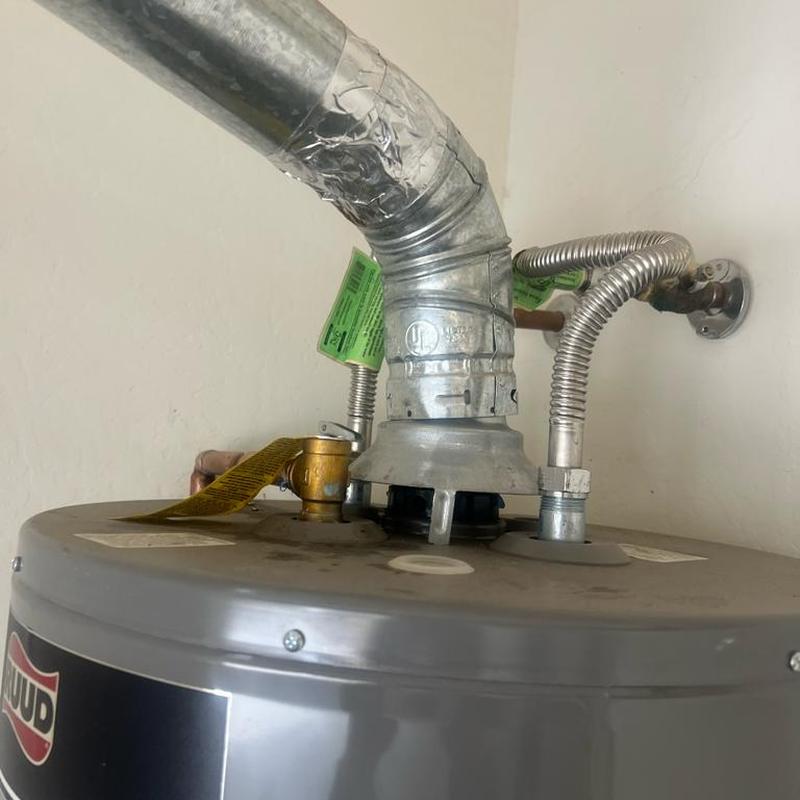 Water heater vent hood secured with screws