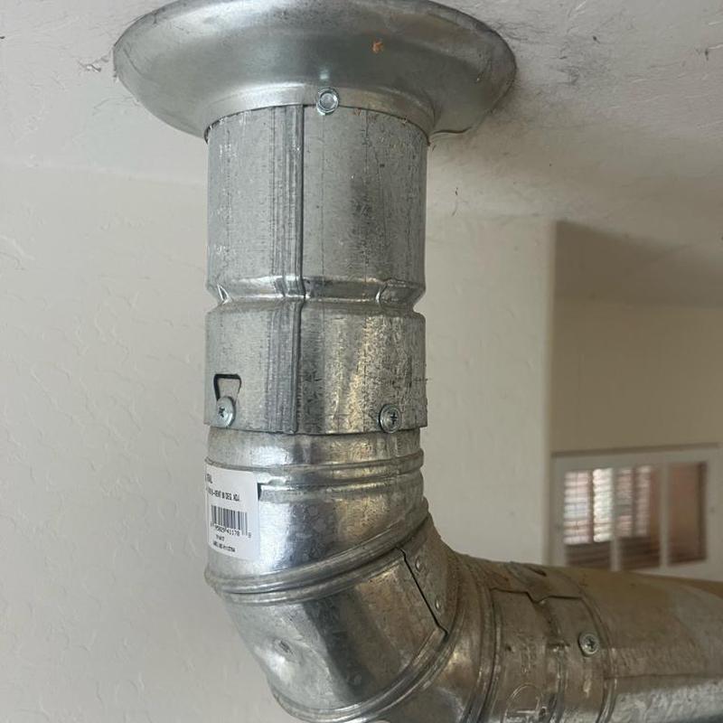 Water heater vent hood with new screws installed