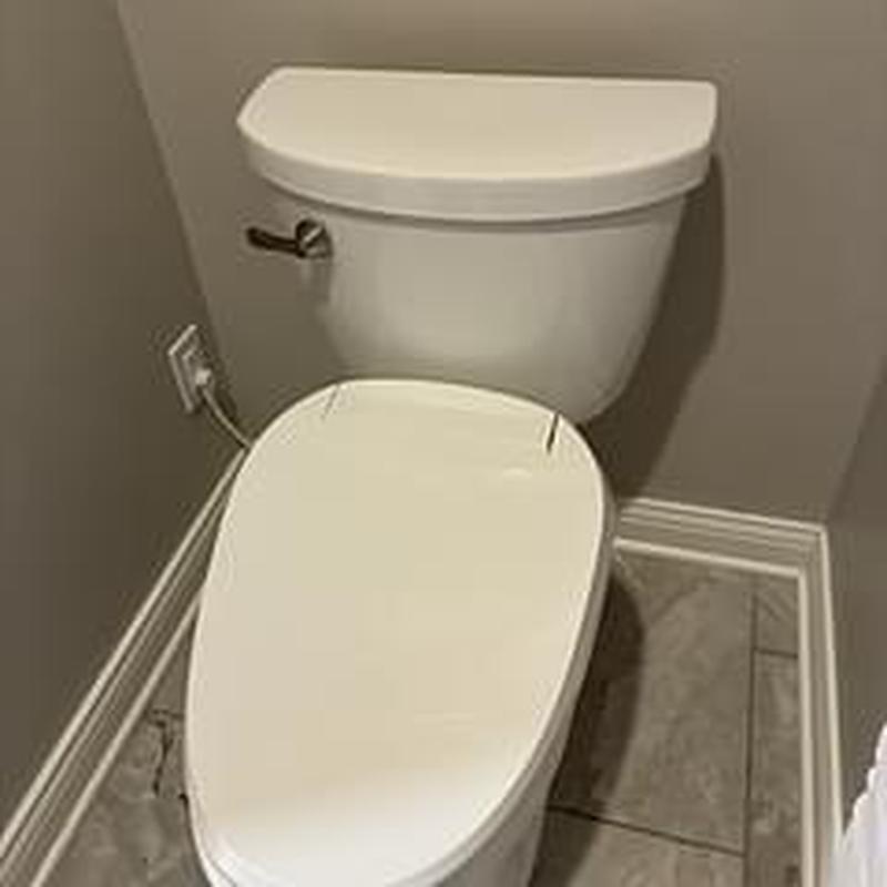 Toilet with replaced wax ring in bathroom corner