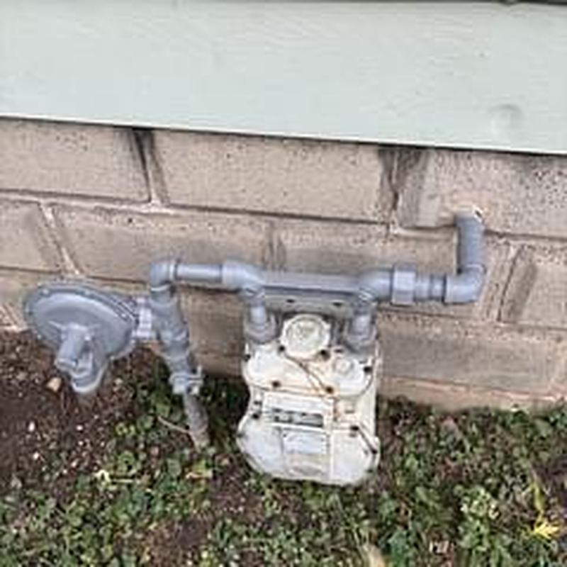 Gas meter and piping pressure test near brick wall