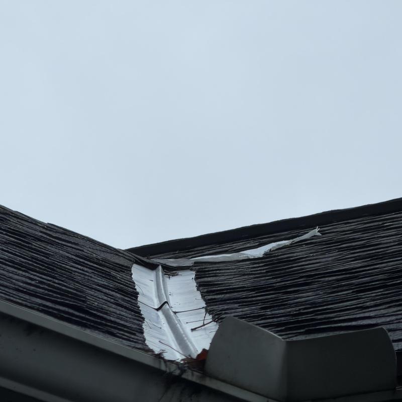 Roof valley metal flashing with damaged shingles