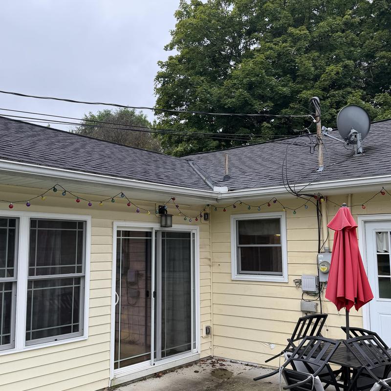Asphalt shingle roof with satellite dish and patio furniture