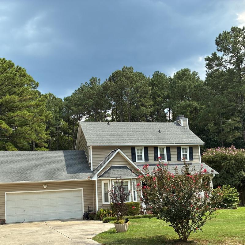 Asphalt shingle roof on two-story home exterior Asphalt shingle roof on two-story home exterior