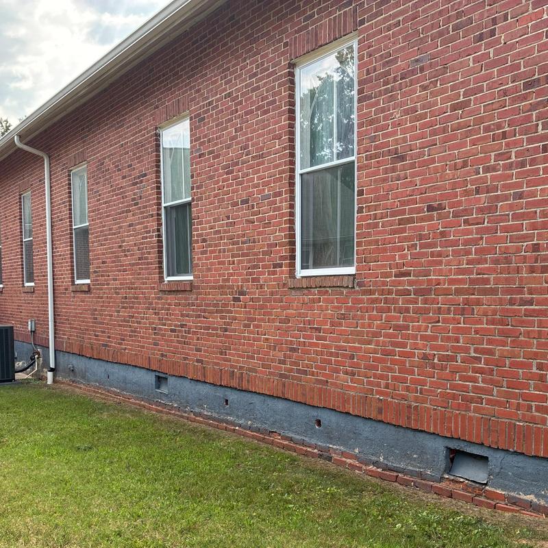 Brick exterior wall and downspout installation on church Brick exterior wall and downspout installation on church
