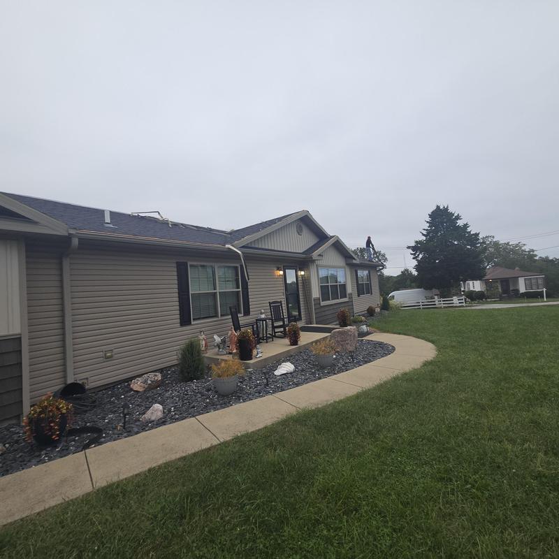 Asphalt shingle roof on residential home with lawn